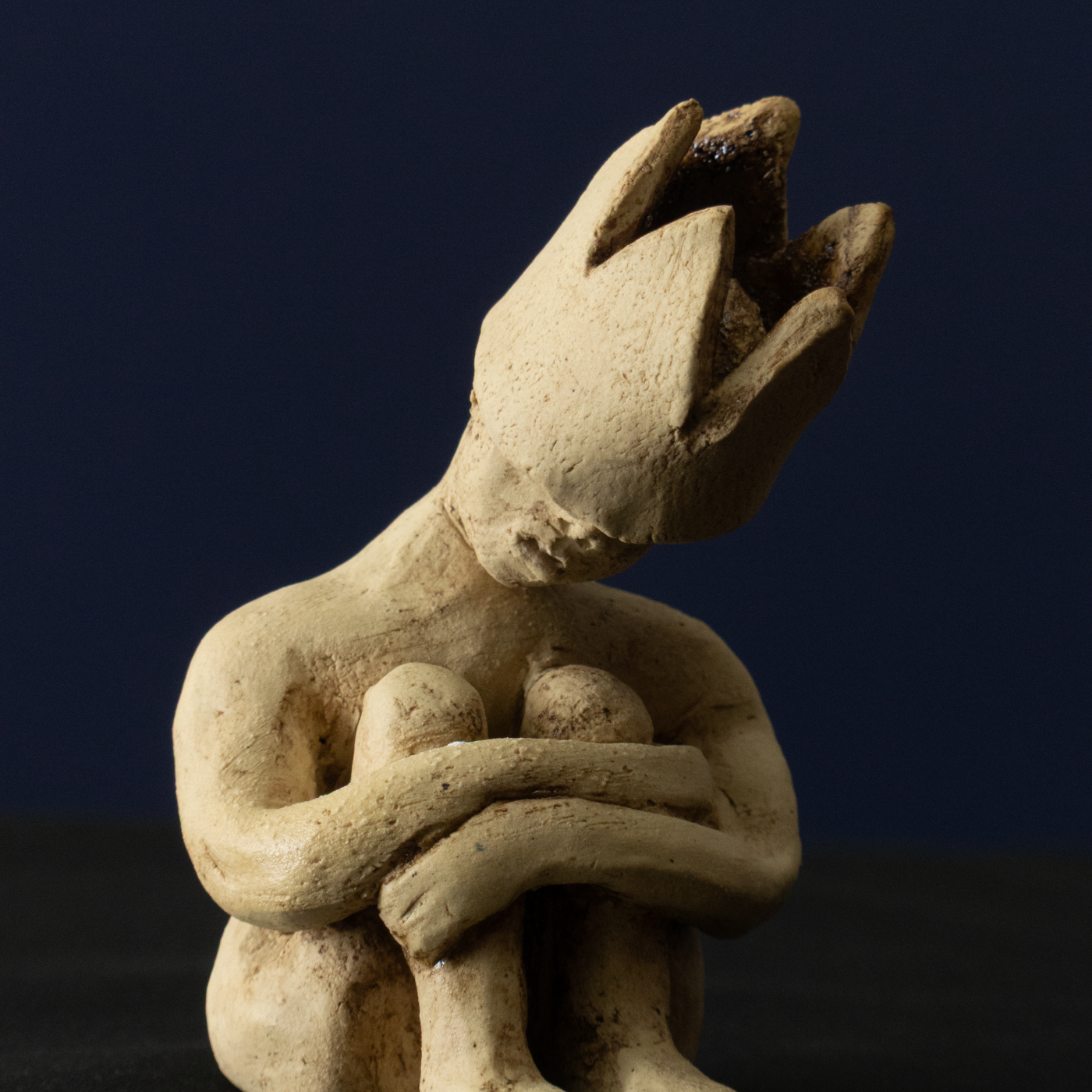 Keramik-Skulptur „Im Rückzug“ von Jutta Eger, weißer Ton mit Engobe, figurative reduzierte Form in zurückgezogener Haltung, Vorderansicht rechts